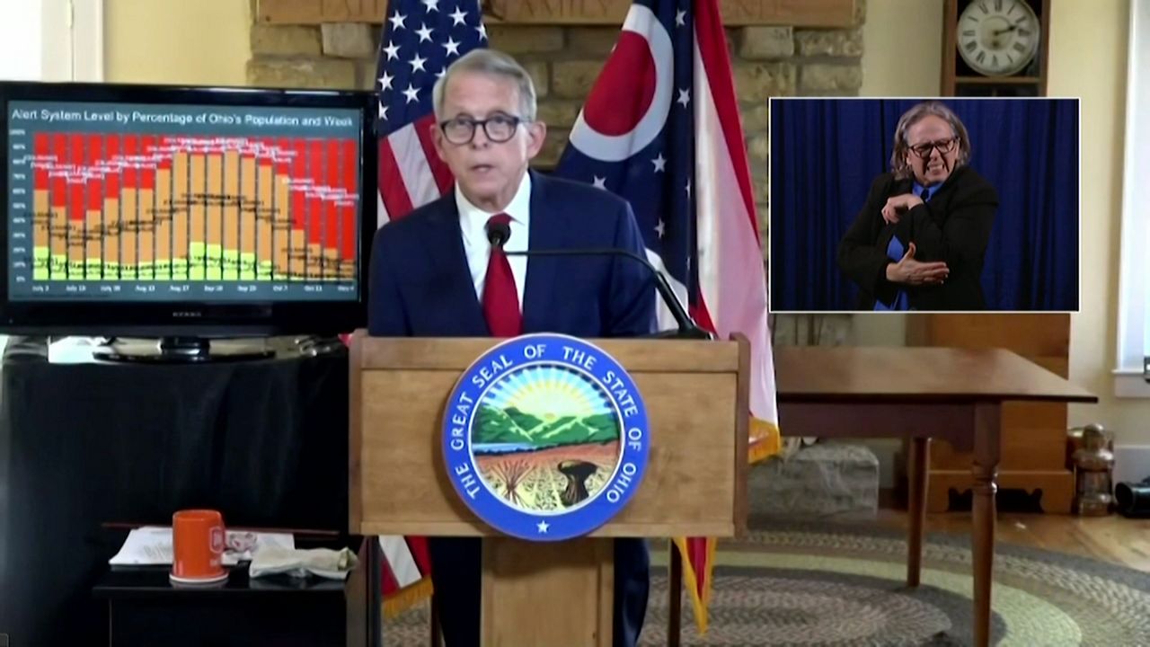 Mike DeWine speaks from a podium