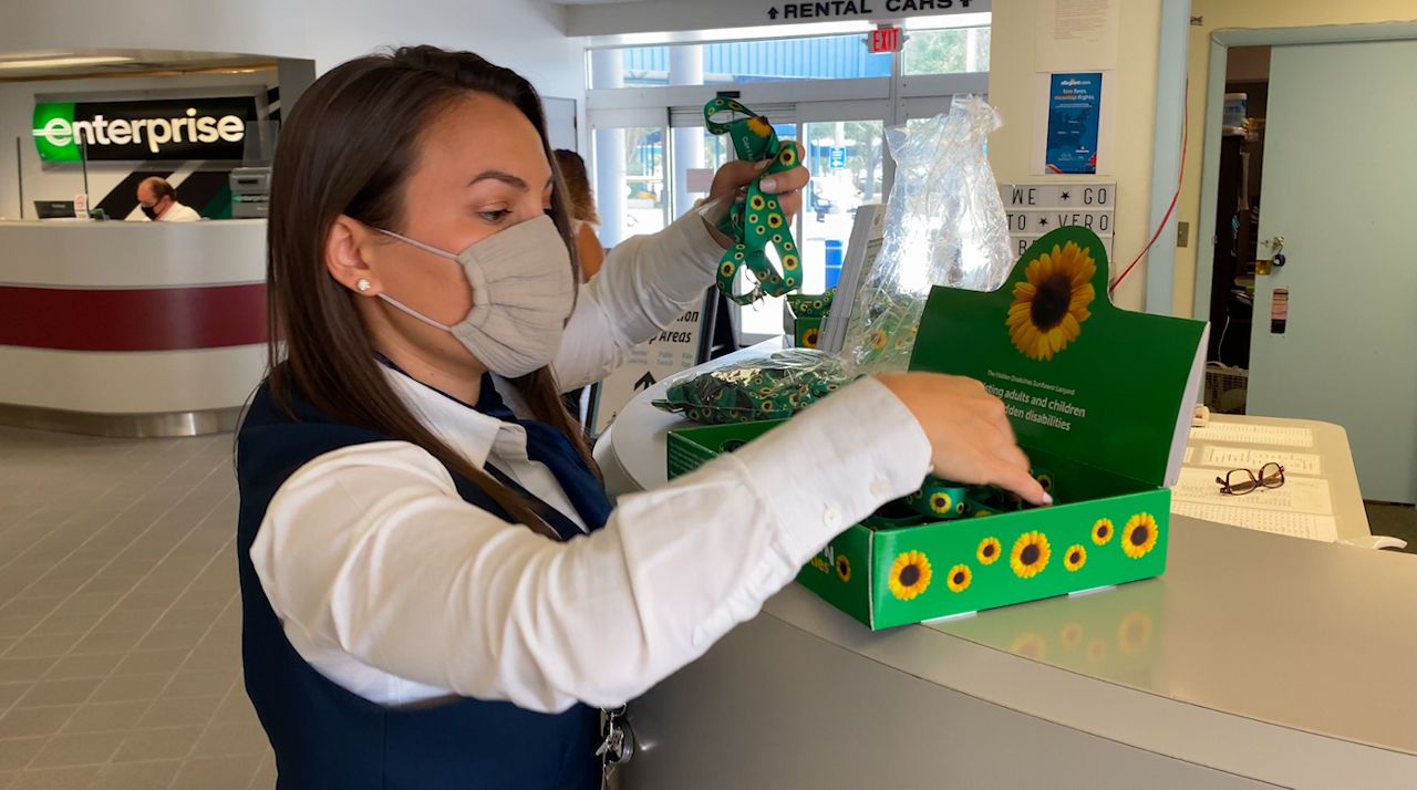 Melbourne Orlando International Airport ambassador Anushka Boyd prepares bright green and yellow lanyards as part of the airport's Sunflower Program for people with "hidden disabilities." (Spectrum News 13/Greg Pallone)