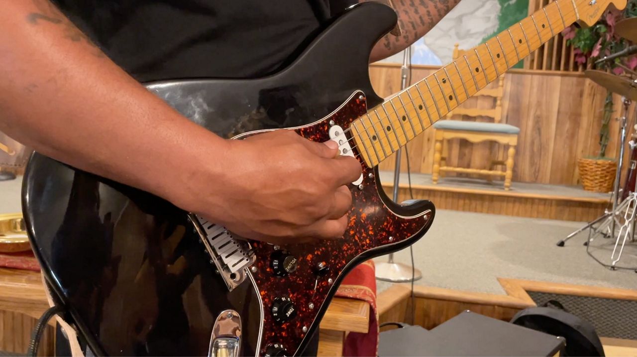 Lead guitarist, T.C. Carter rehearsing ahead of the festival. 
