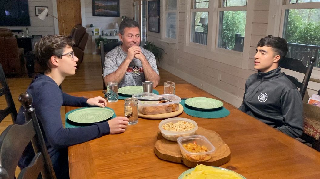 Jeff Gaura and his students sitting down for dinner
