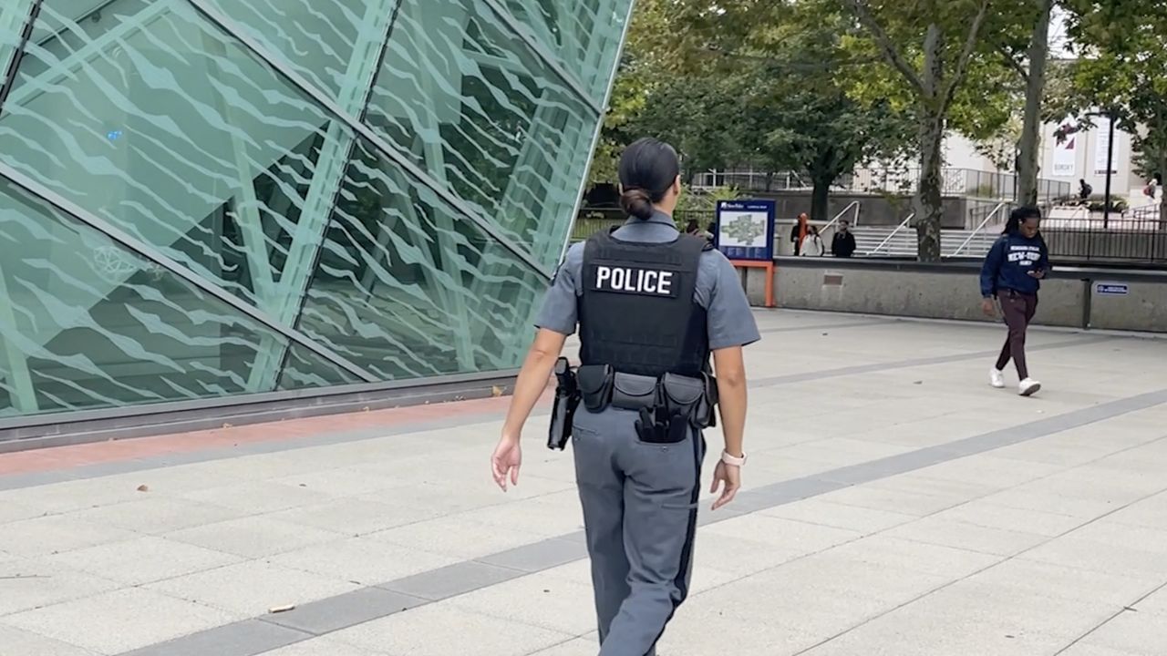 Police officer walks on campus.