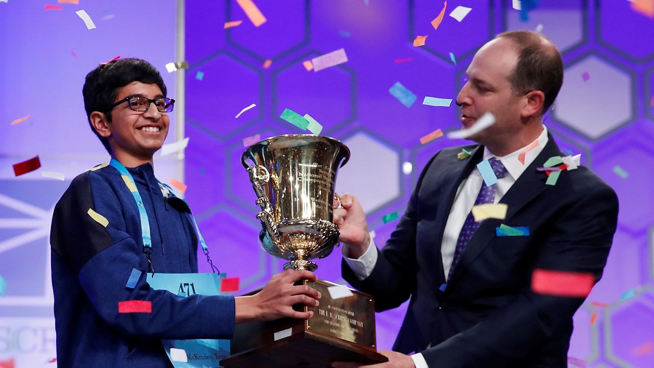 Karthik Nemmani, 14, holds the Scripps National Spelling Bee Championship Trophy after his 2018 victory. (AP/Carolyn Kaster)