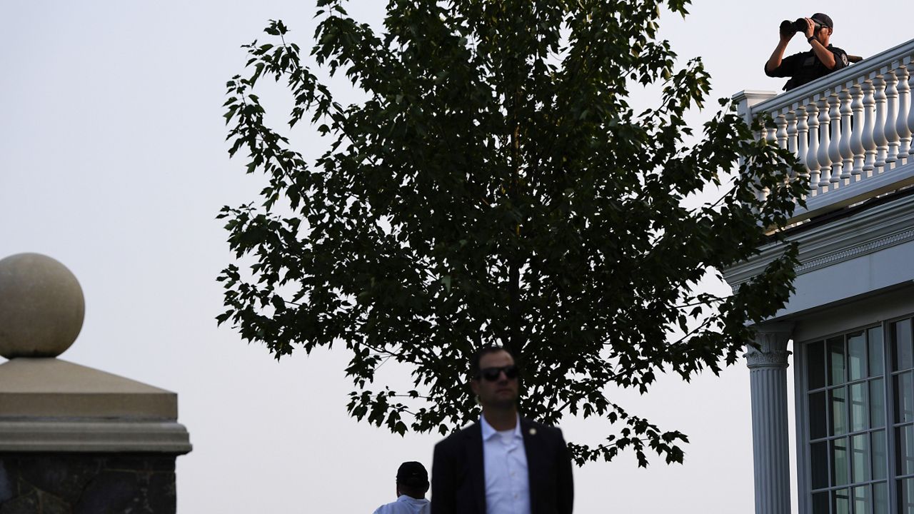 U.S. Secret Service agents stand watch as Republican presidential nominee former President Donald Trump speaks at a news conference at Trump National Golf Club, Aug. 15, 2024, in Bedminster, N.J. (AP Photo/Julia Nikhinson, File)