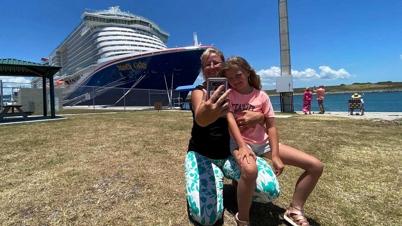 Vickie Walton and her daughter, Marissa, snap a selfie in front of Carnival's newest cruise ship, the Mardi Gras. (Spectrum News 13/Will Robinson-Smith)