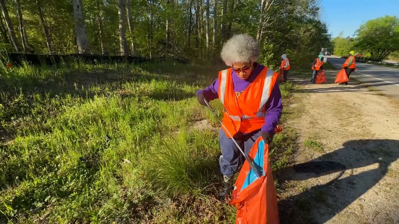 Selma Cash, a volunteer with Elevation Baptist Church, helps pick up litter along roadways in Wake County. (Spectrum News 1/Amy Elliott)