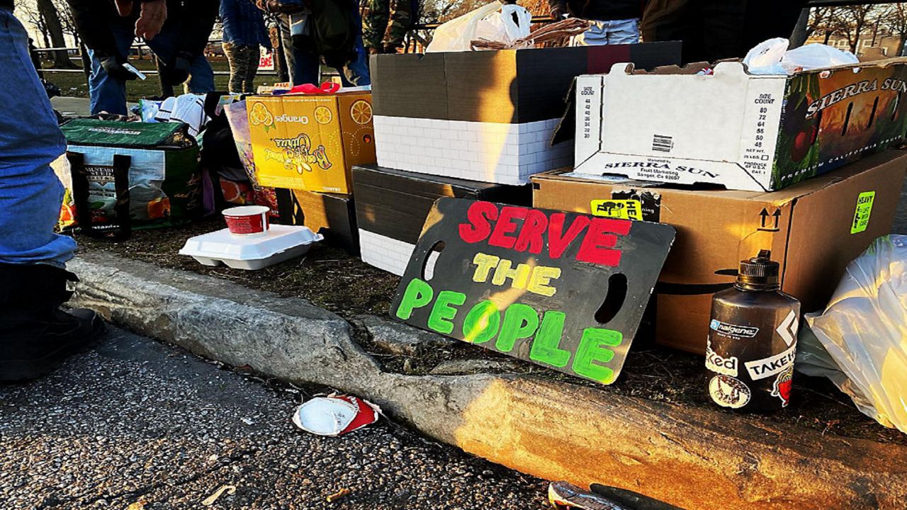 volunteer group sign at homeless encampment