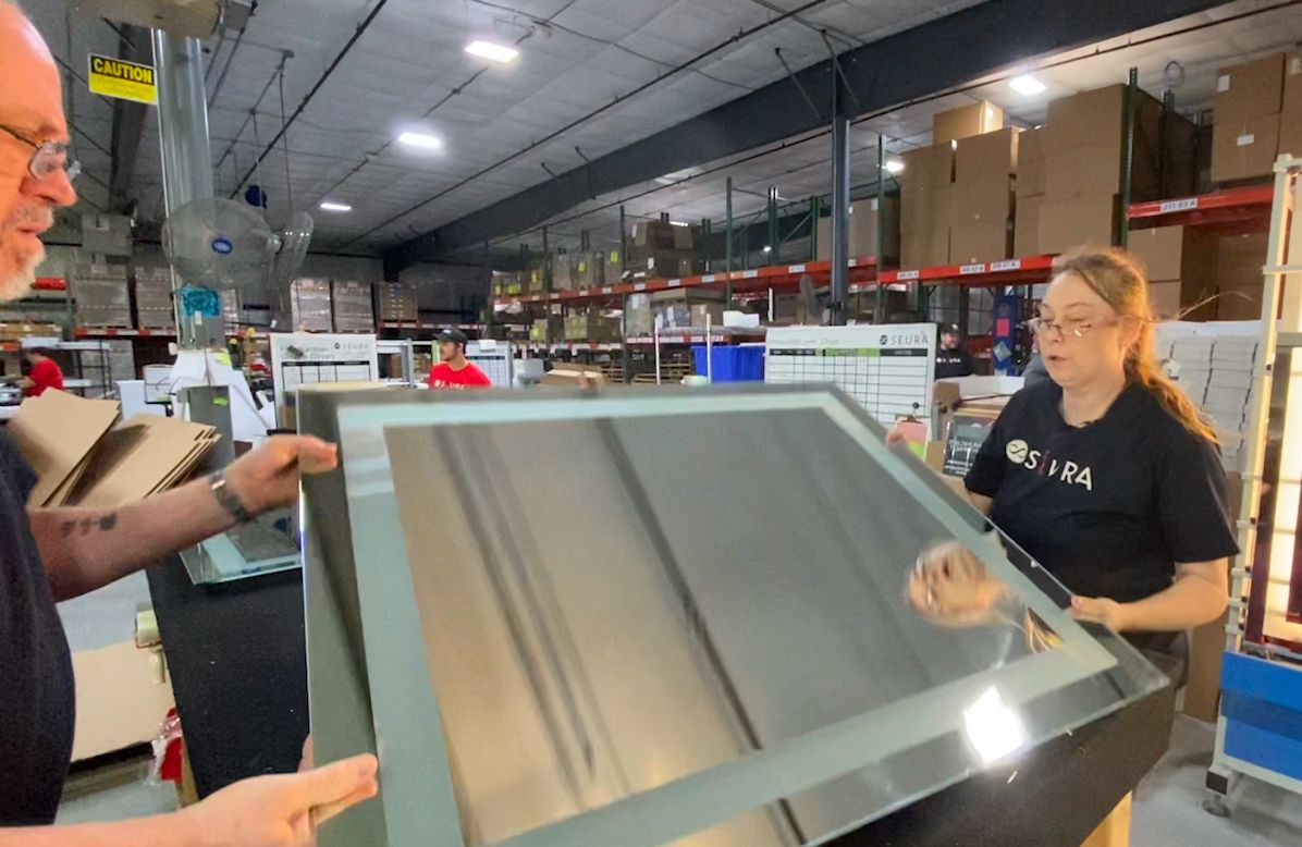 Lisa Metzler moves a mirror at Seúra in Green Bay, Wisconsin.