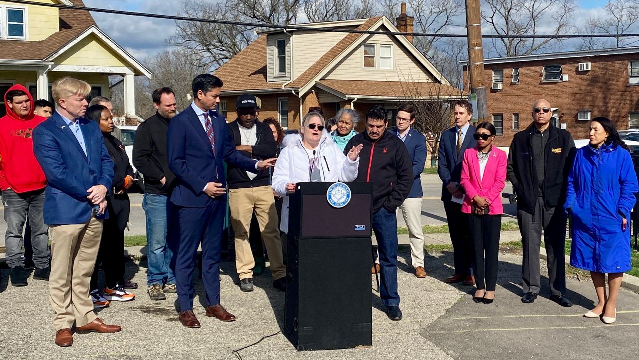 Shawna and Eduardo Rodriguez surrounded by city leads and community advocates at a City of Cincinnati pedestrian safety announcement in East Westwood. (Casey Weldon/Spectrum News 1)