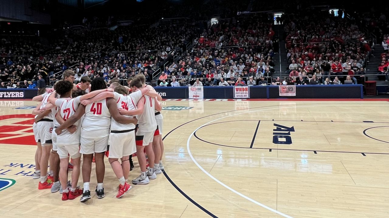 The Shelby High School boys basketball team huddles together on the court during the OHSAA Boys State Tournament semifinal at UD Arena on Saturday.