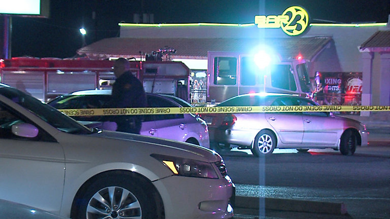 Woman shot after driving car at security guard at Bar 23. 