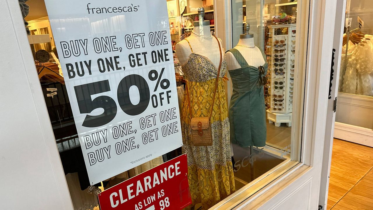 A sign trumpets discounts available in a clothing store in a mall Monday, April 29, 2024, in Lone Tree, Colo. (AP Photo/David Zalubowski)