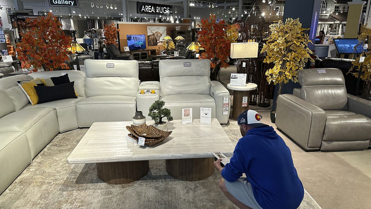 A shopper pauses at a display in a furniture store Sunday, June 2, 2024, in Englewood, Colo. (AP Photo/David Zalubowski)