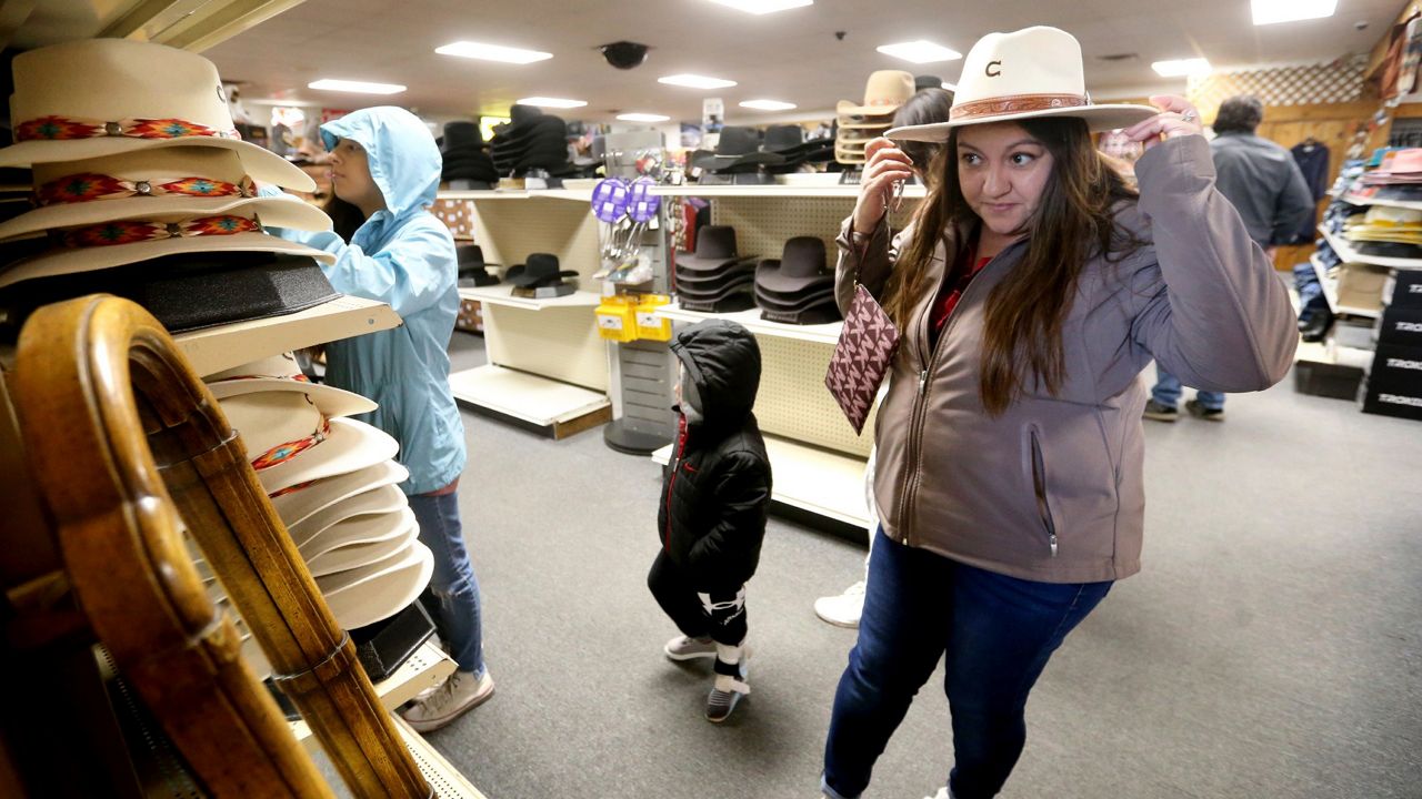 Irene Schaefer, of Johnson Creek, Wis., shops for hats at Longhorn Saddlery in Dubuque, Iowa, on Dec. 30. (Jessica Reilly/Telegraph Herald via AP)