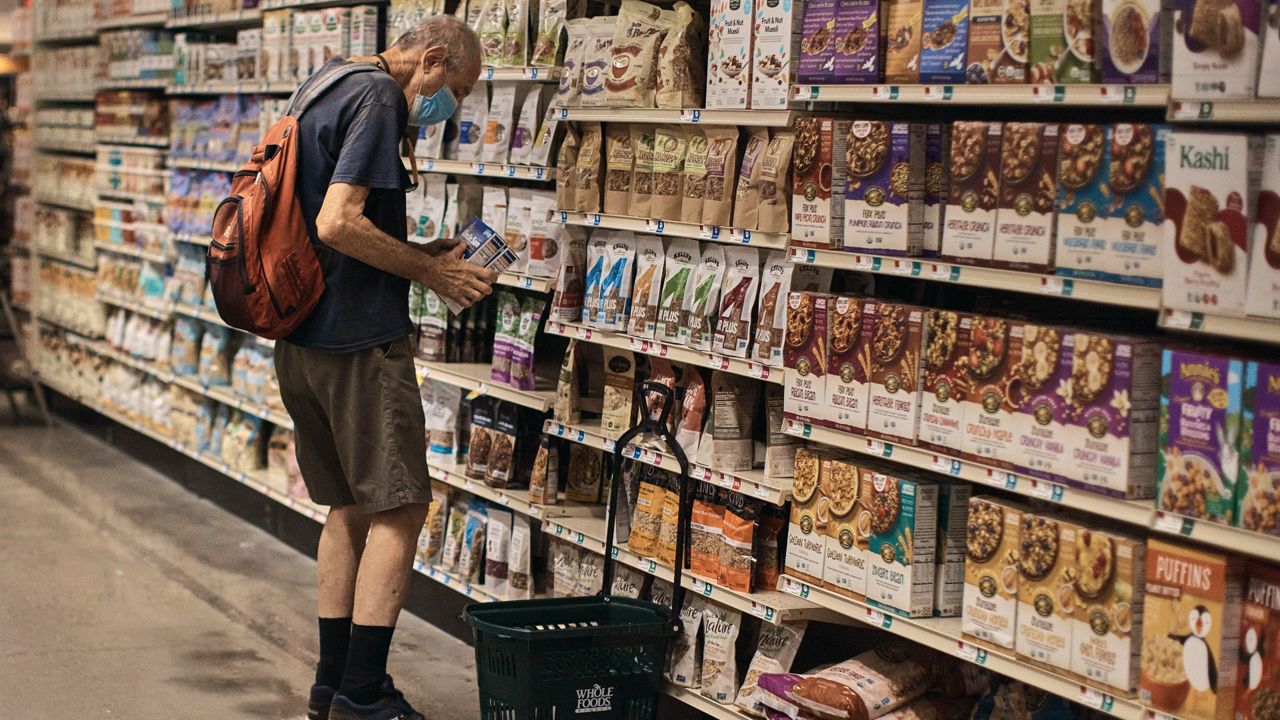 A man shops at a supermarket Wednesday in New York. (AP Photo/Andres Kudacki)