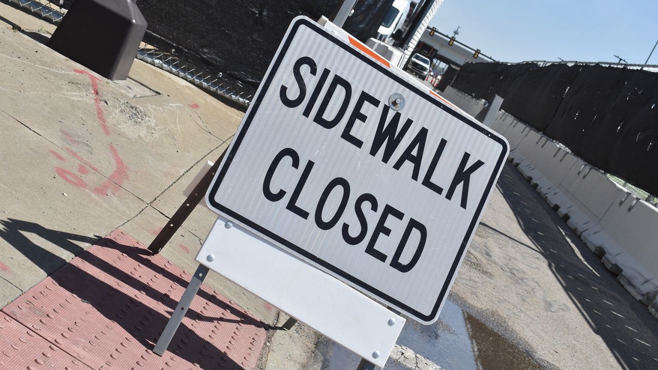 A sidewalk closed sign. (Spectrum News 1/Cody Thompson)