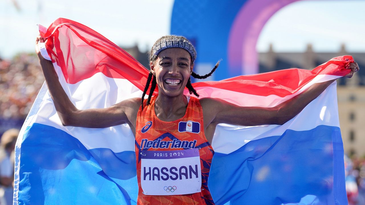 Sifan Hassan of the Netherlands celebrates after crossing the finish line to win the gold medal in the women's marathon at the 2024 Summer Olympics, Sunday, Aug. 11, 2024, in Paris, France. (AP Photo/Vadim Ghirda)