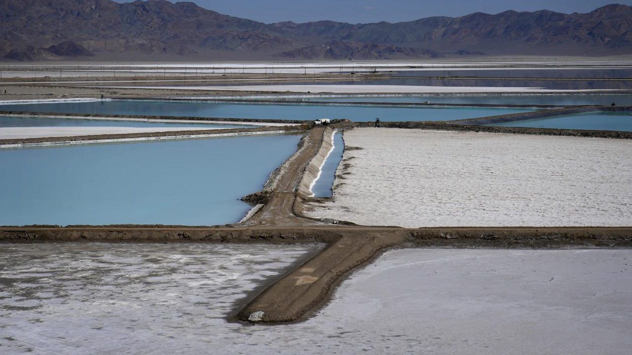 A truck is parked between brine evaporation ponds at Albemarle Corp.'s Silver Peak lithium facility, Oct. 6, 2022, in Silver Peak, Nev. The Energy Department is making a push to strengthen the U.S. battery supply chain, announcing Wednesday, Nov. 15, 2023, up to $3.5 billion for companies that produce batteries and the critical minerals that go into them. (AP Photo/John Locher, File)