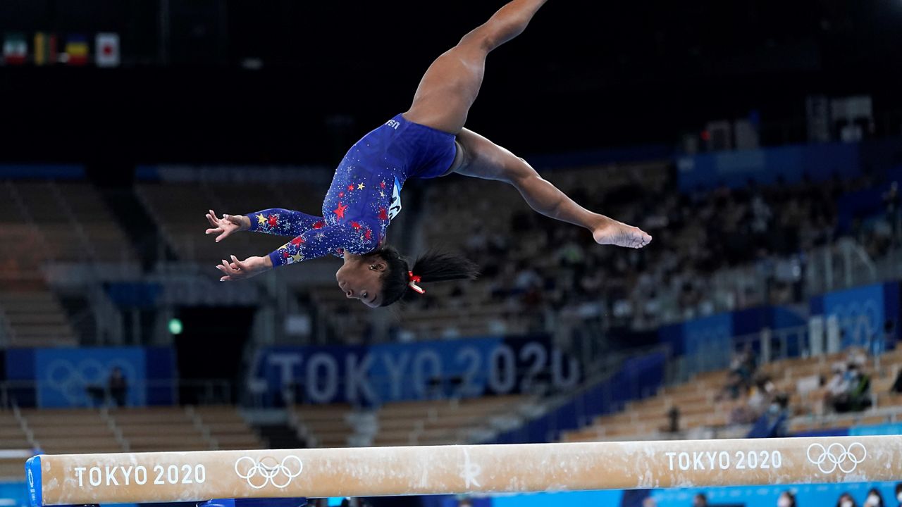 Simone Biles performs on the balance beam during the women's artistic gymnastic qualifications at the 2020 Olympics in Tokyo. (AP/Ashley Landis)