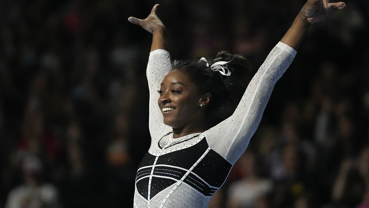 Simone Biles reacts after performing in the floor exercise at the U.S. Classic gymnastics competition Saturday, Aug. 5, 2023, in Hoffman Estates, Ill. (AP Photo/Erin Hooley)