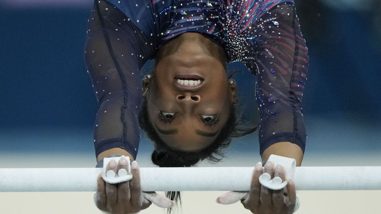 Simone Biles of the United States practices the uneven bars during a gymnastics training session at Bercy Arena at the 2024 Summer Olympics, Thursday, July 25, 2024, in Paris, France. (AP Photo/Charlie Riedel)