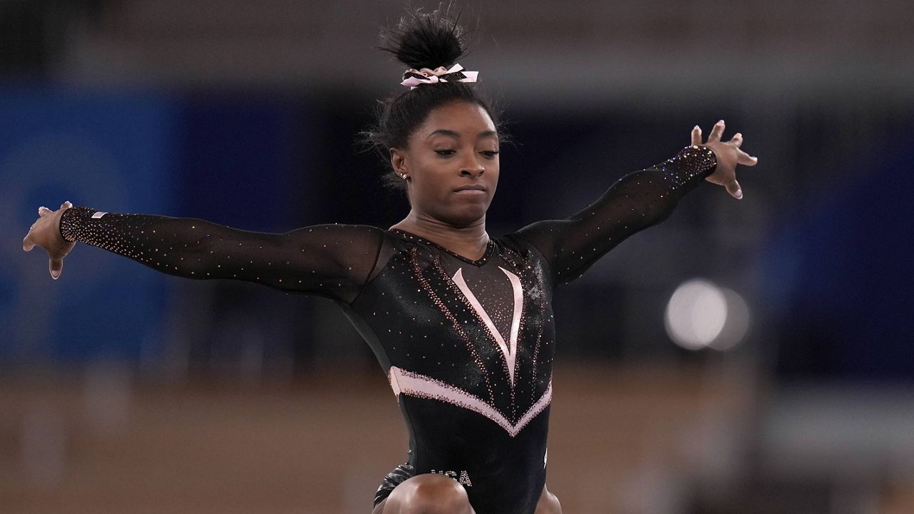 Simone Biles trains on the floor exercise during an artistic gymnastics practice session at the 2020 Summer Olympics in Tokyo. (AP Photo/Gregory Bull)