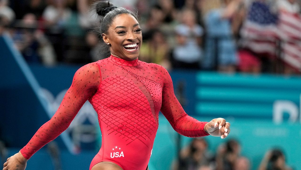 Simone Biles, of the United States, smiles after competing during the women's artistic gymnastics individual vault finals at Bercy Arena at the 2024 Summer Olympics, Saturday, Aug. 3, 2024, in Paris, France. (AP Photo/Charlie Riedel)