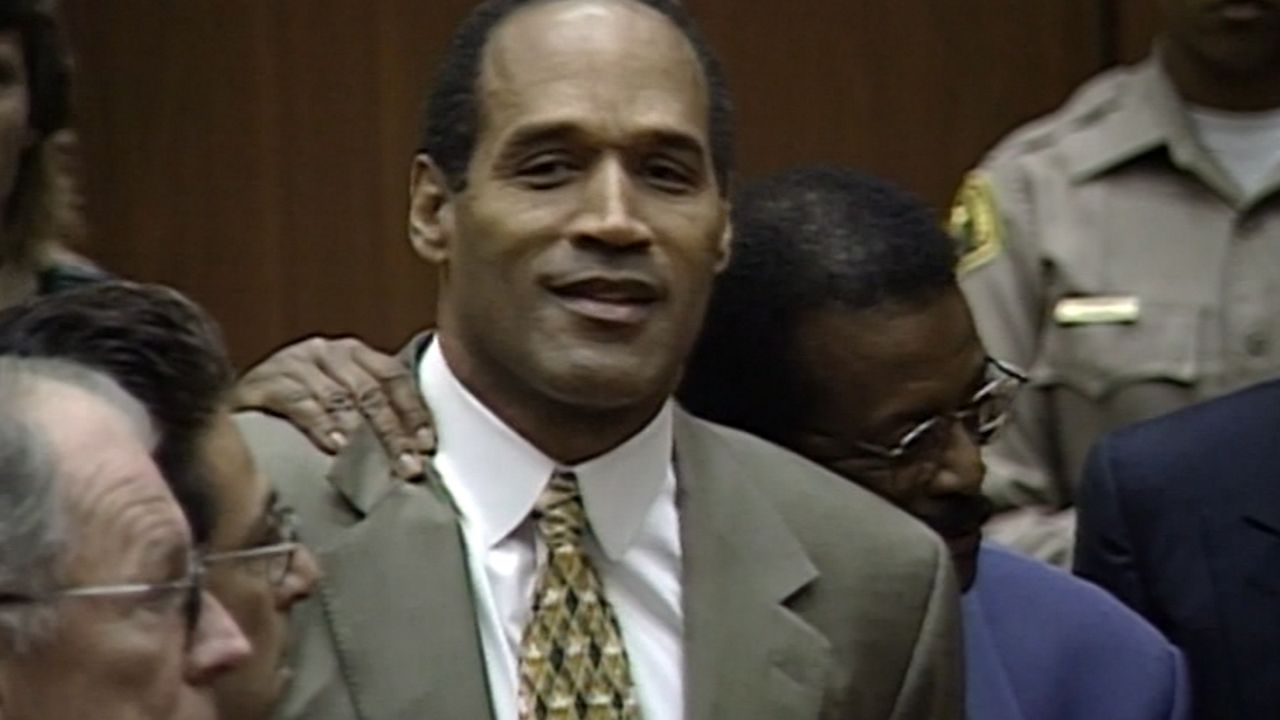 OJ Simpson stands on the side lines during a University of