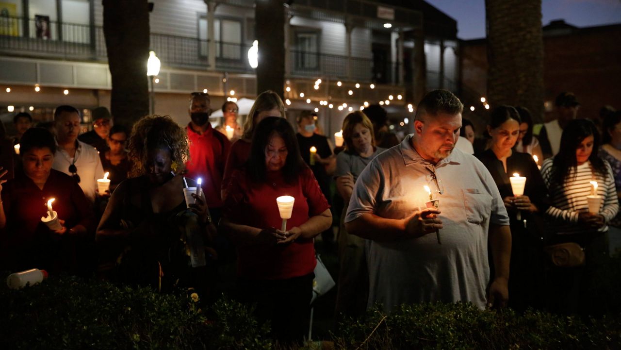 Community members attend a candlelight vigil for the Singh family at Bob Hart Square in Merced, Calif., on Thursday, Oct. 6, 2022. Four members of the Singh family were abducted and killed this week. The suspect in the kidnapping and killings of an 8-month-old baby, her parents and an uncle had worked for the family’s trucking business and had a longstanding feud with them that culminated in an act of “pure evil,” a sheriff said Thursday. (Salgu Wissmath/San Francisco Chronicle via AP)