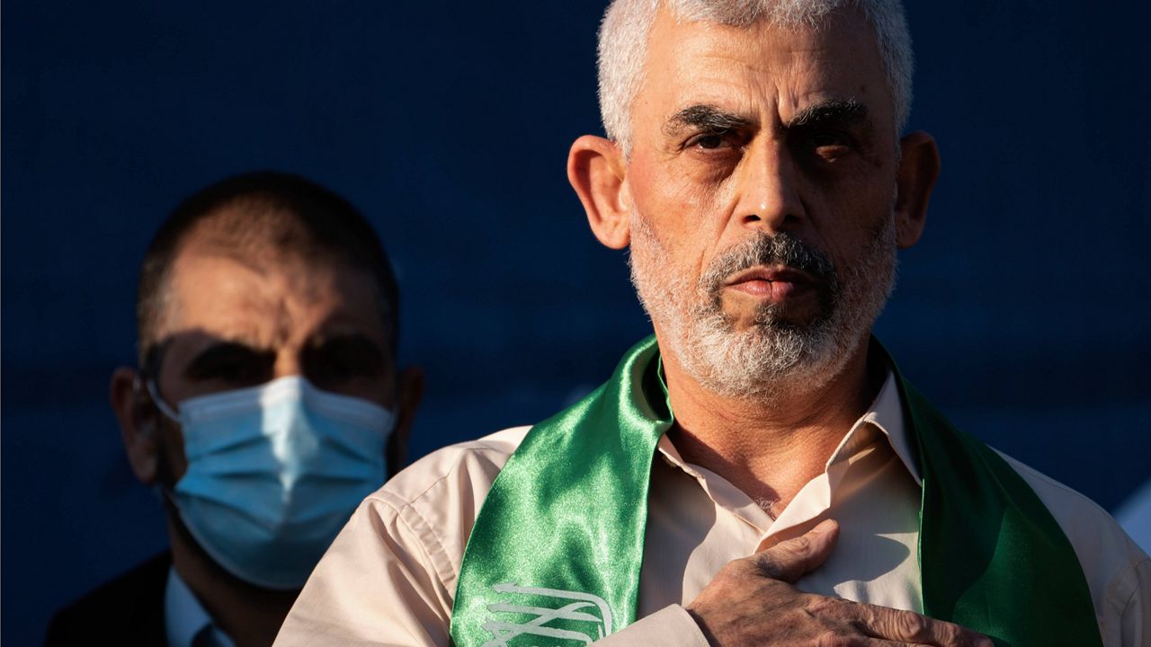 Yahya Sinwar, Palestinian leader of Hamas in the Gaza Strip, places his hand over his heart on stage after greeting supporters at a rally on May 24, 2021, in Gaza City, the Gaza Strip. (AP Photo/John Minchillo, File)