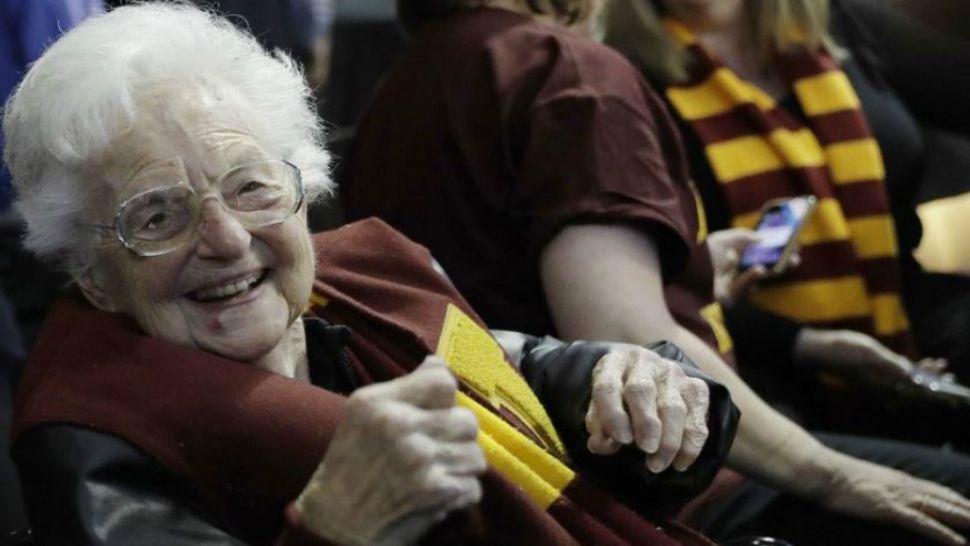 This March 22, 2018, file photo shows Sister Jean Dolores Schmidt sitting with other Loyola-Chicago fans during the first half of a regional semifinal NCAA college basketball game against Nevada in Atlanta. (AP Photo/David Goldman)