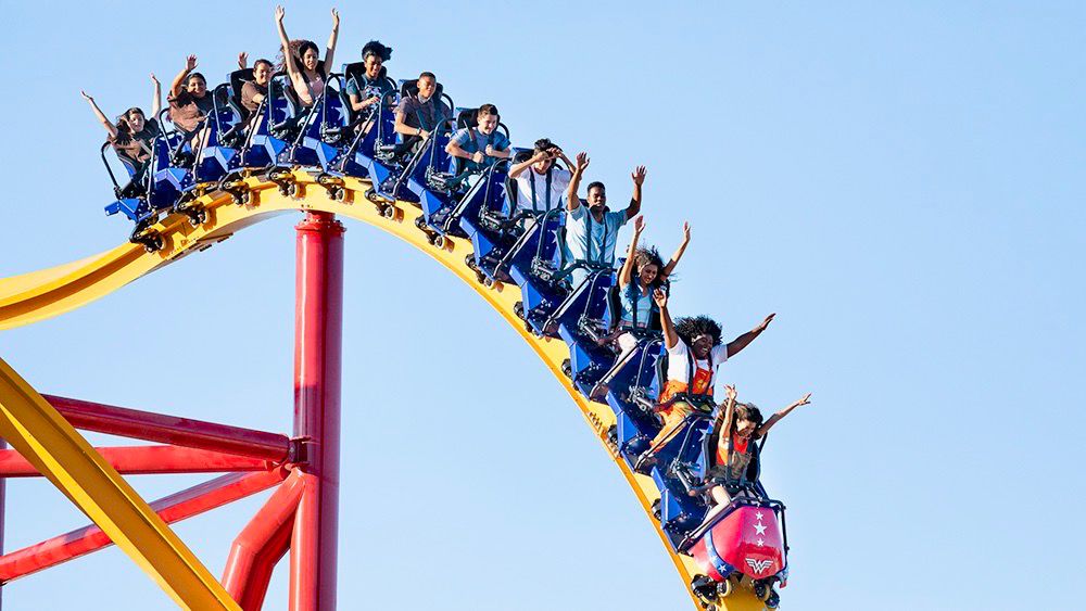 Visitors ride the Wonder Woman attraction at Six Flags