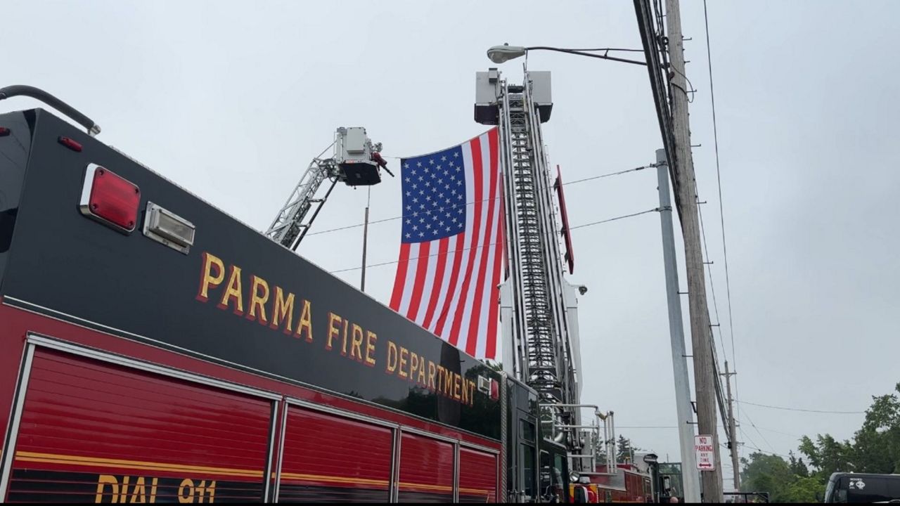 A Parma Fire Department truck displays the U.S. flag outside the church.