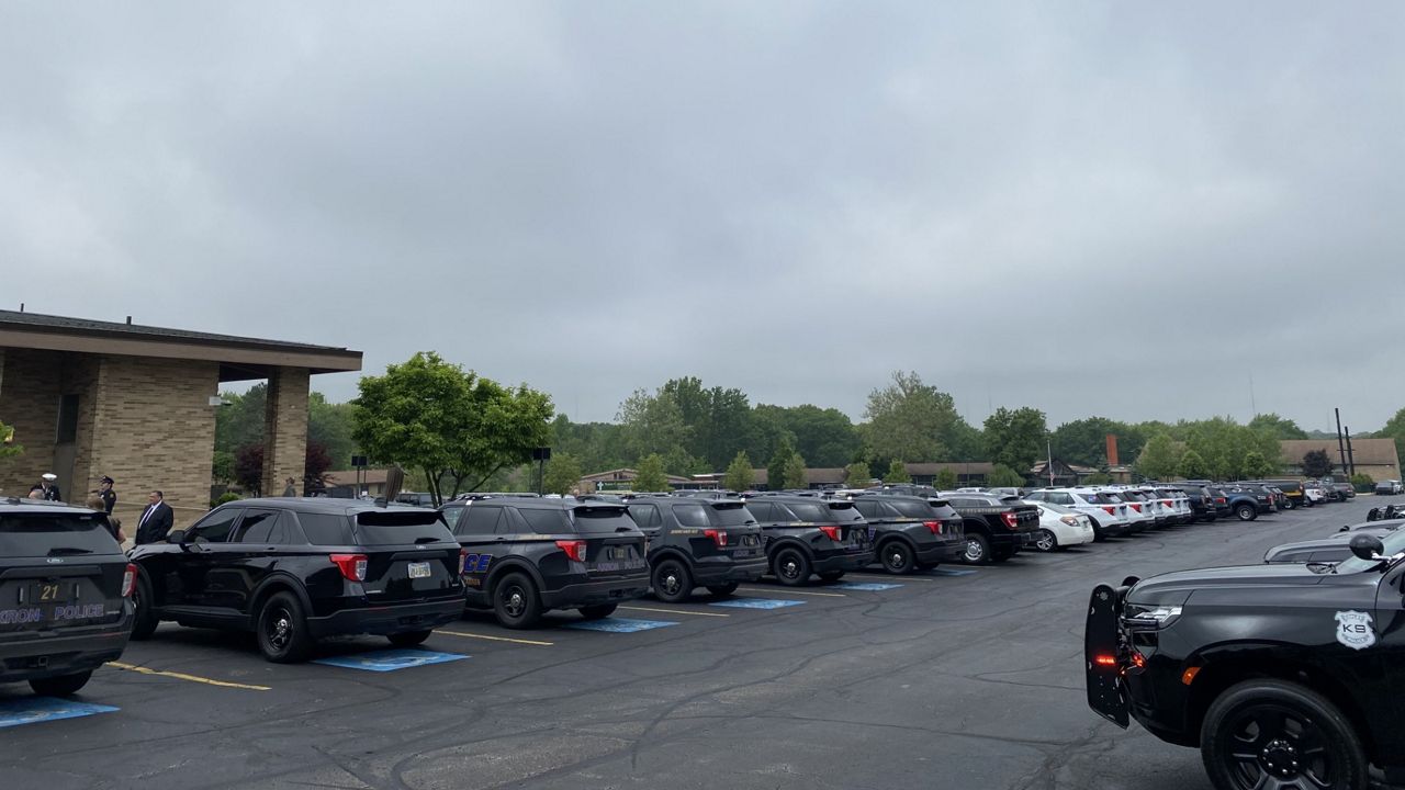 Police vehicles pack the church parking lot for the funeral.