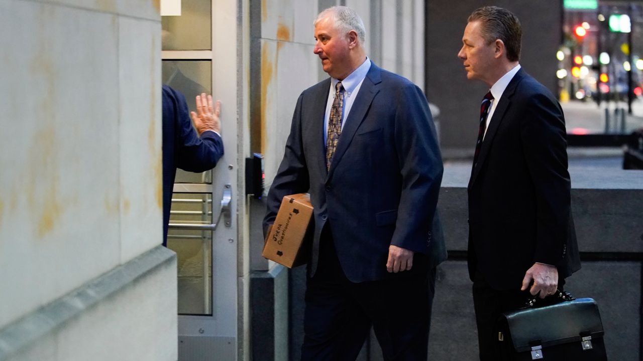 Former Ohio House Speaker Larry Householder, center, walks into Potter Stewart U.S. Courthouse with his attorneys, Mark Marein, left, and Steven Bradley, right, before jury selection in his federal trial, Friday, Jan. 20, 2023, in Cincinnati.