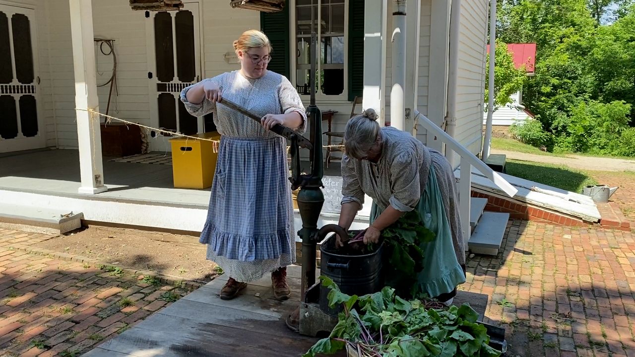 Two Slate Run workers clean vegetables at Slate Run. 