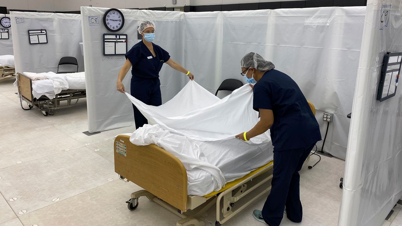 This photo from the California Office of Emergency Services (OES) shows hospital beds set up in the practice facility at Sleep Train Arena in Sacramento, Calif., that is ready to receive patients as needed on Dec. 9, 2020. (Photo credit: Cal OES via AP)