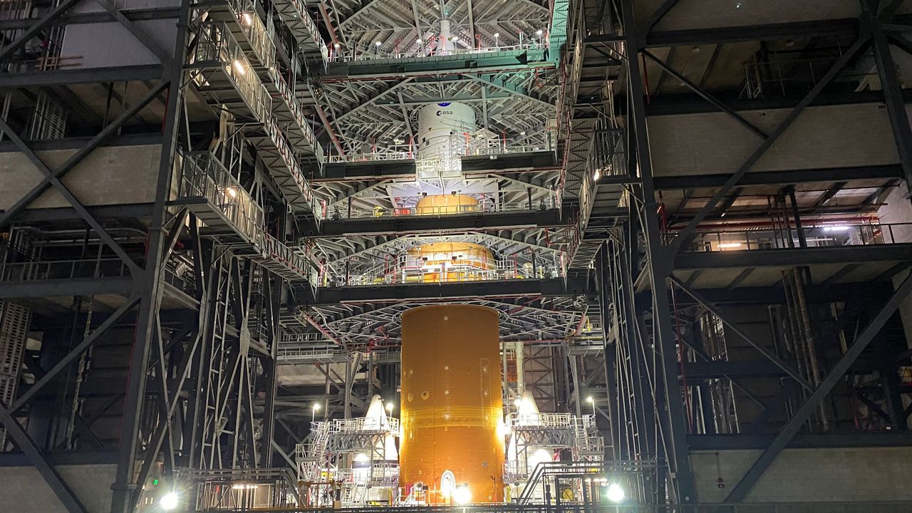 The Space Launch System that will carry the Artemis I mission into space some time in 2022, stands fully stacked inside NASA's Vehicle Assembly Building. (Spectrum News 13/Will Robinson-Smith)
