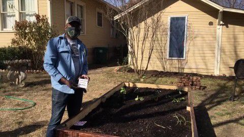 Southside resident James Smith poses in front of his garden. (Image courtesy of Southside Community Garden.)