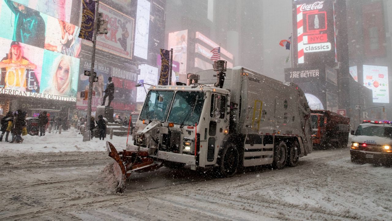 A snow plow pushes snow through Times Square, in the middle of a major snow storm.