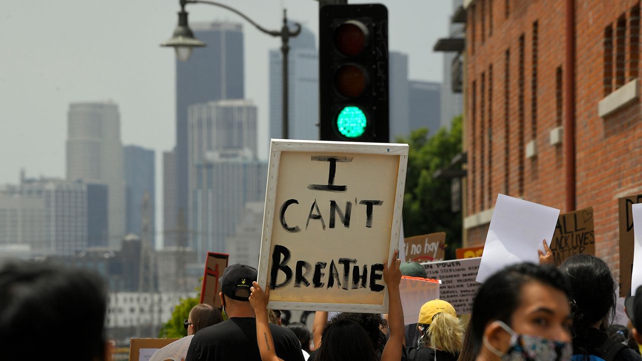 Demonstrators walk toward downtown Los Angeles during a Black Lives Matter protest, Wednesday, June 17, 2020, in Los Angeles. (AP Photo/Mark J. Terrill)