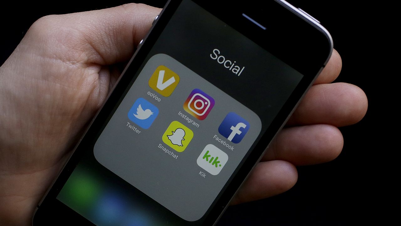 Social media app icons appear on a smartphone (AP Photo/Jeff Chiu)