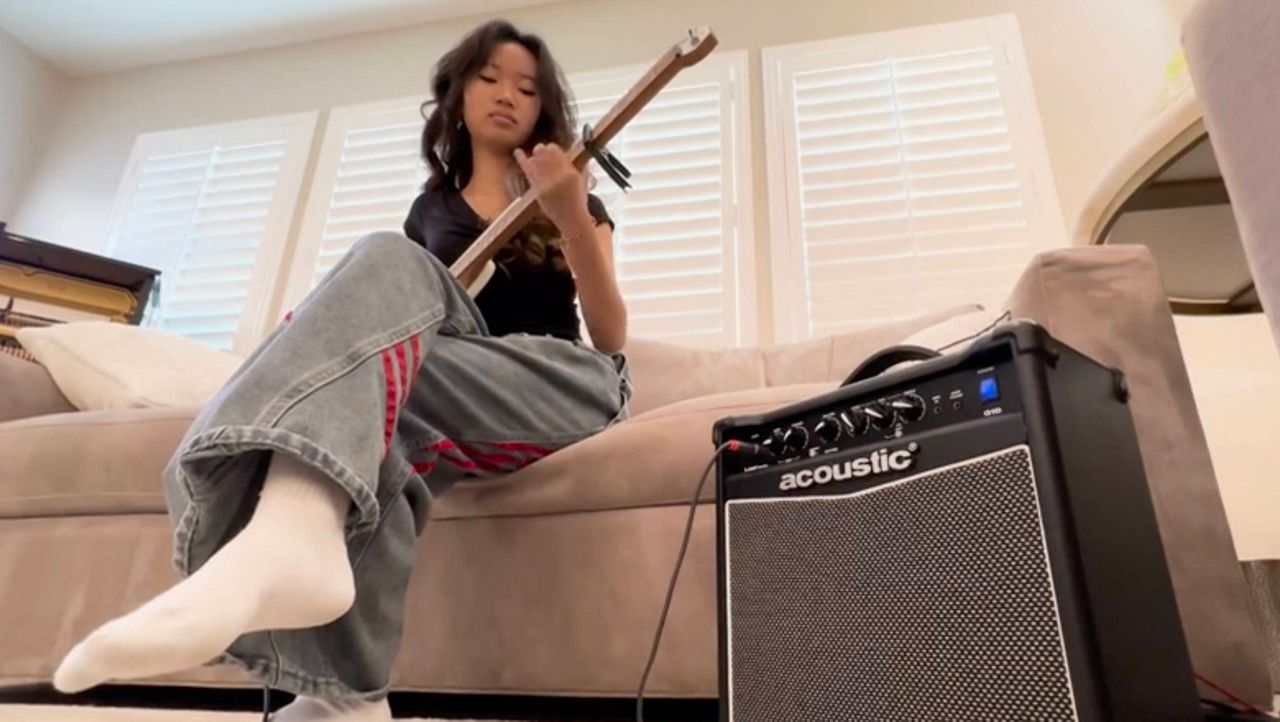 Sophie Yang, 16, says she plays her guitar as a 