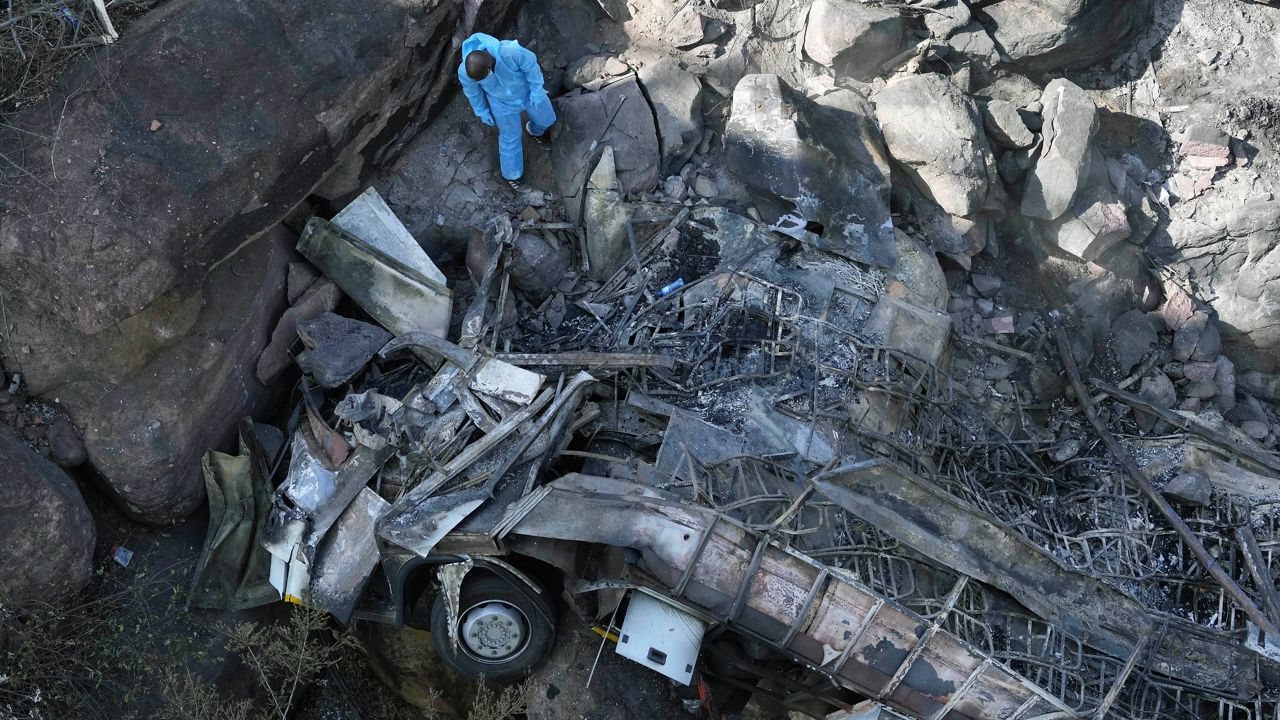 The wreckage of a bus lays in a ravine a day after it plunged off a bridge on the Mmamatlakala mountain pass between Mokopane and Marken, around 190 miles north of Johannesburg, South Africa, Friday, March 29, 2024. (AP Photo/Themba Hadebe)