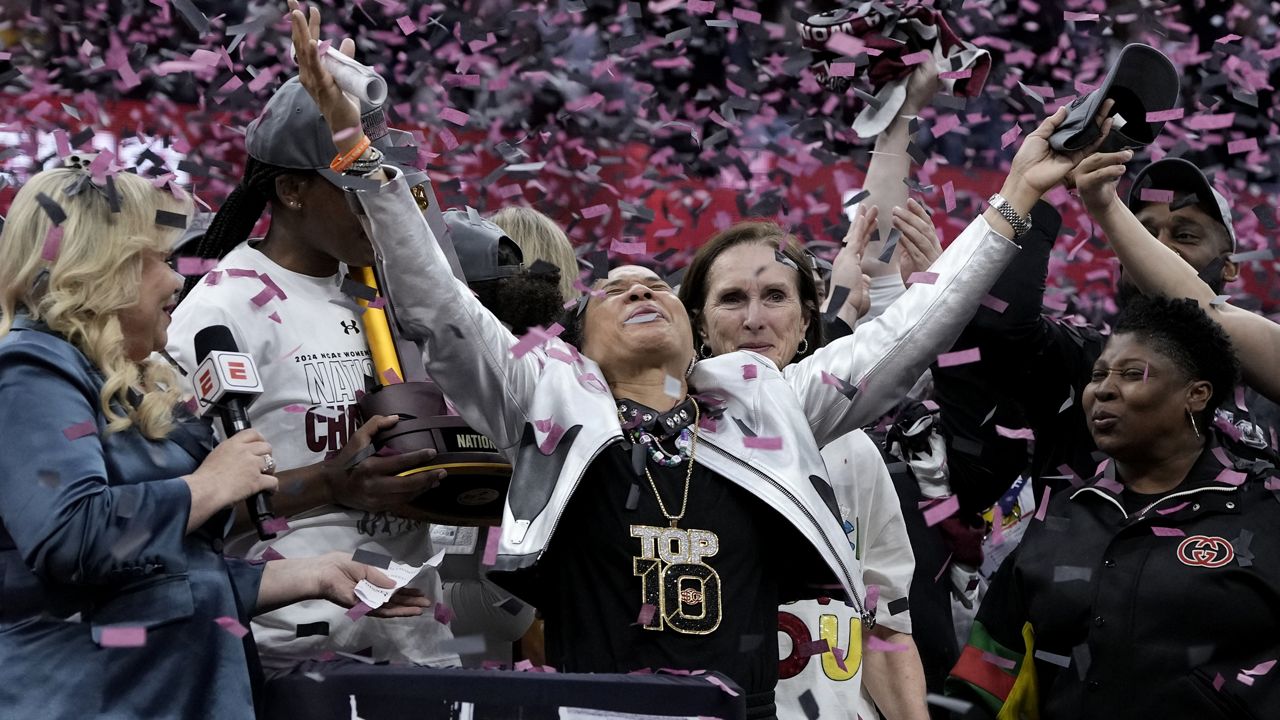 South Carolina head coach Dawn Staley celebrates after the Final Four college basketball championship game against Iowa in the women's NCAA Tournament, Sunday, April 7, 2024, in Cleveland. South Carolina won 87-75. (AP Photo/Morry Gash)