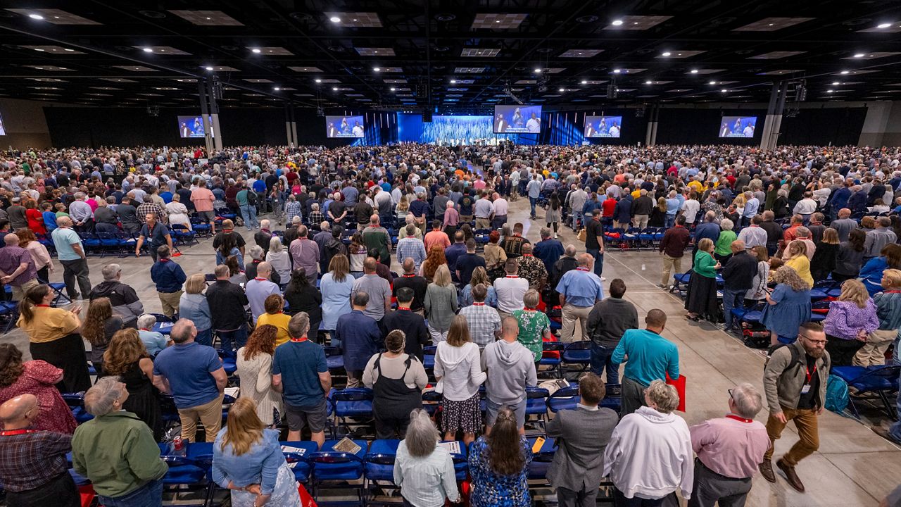 Delegates, also known as messengers, stand for worship during a Southern Baptist Convention annual meeting Tuesday, June 11, 2024, in Indianapolis. (AP Photo/Doug McSchooler)