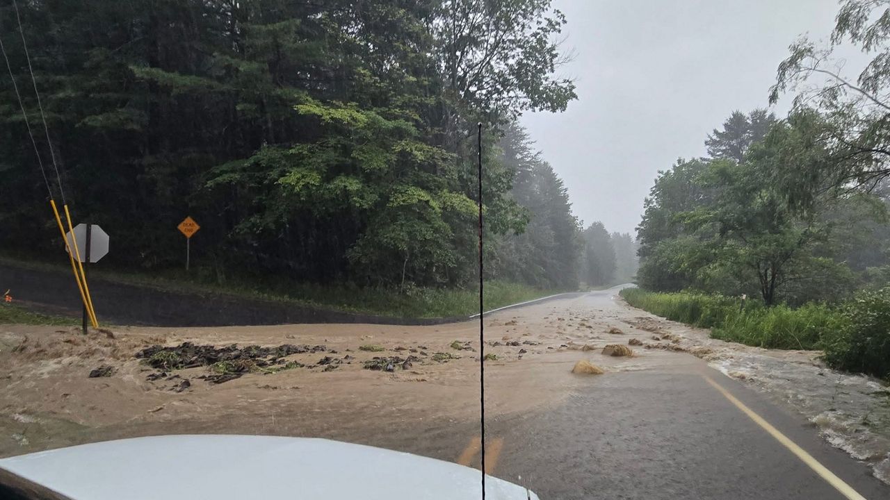flooding on a road, as seen from inside a car