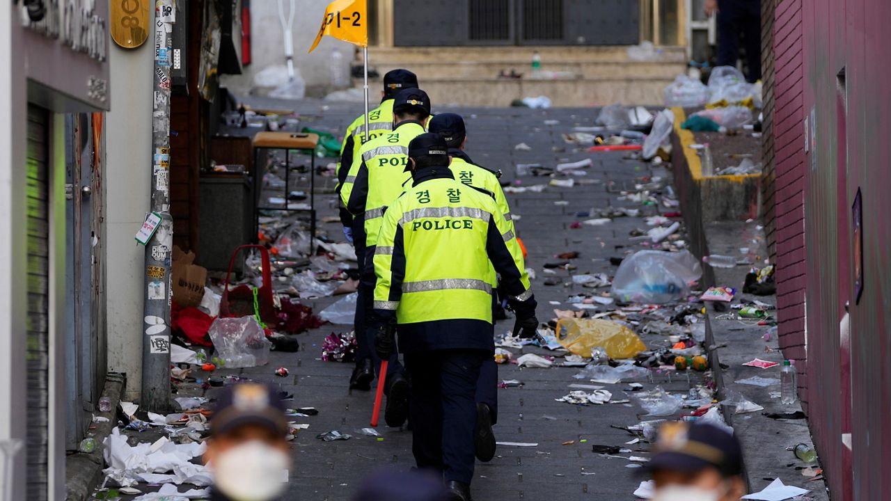 Police officers work at the scene of a fatal crowd surge, in Seoul, South Korea, Sunday, Oct. 30, 2022. 