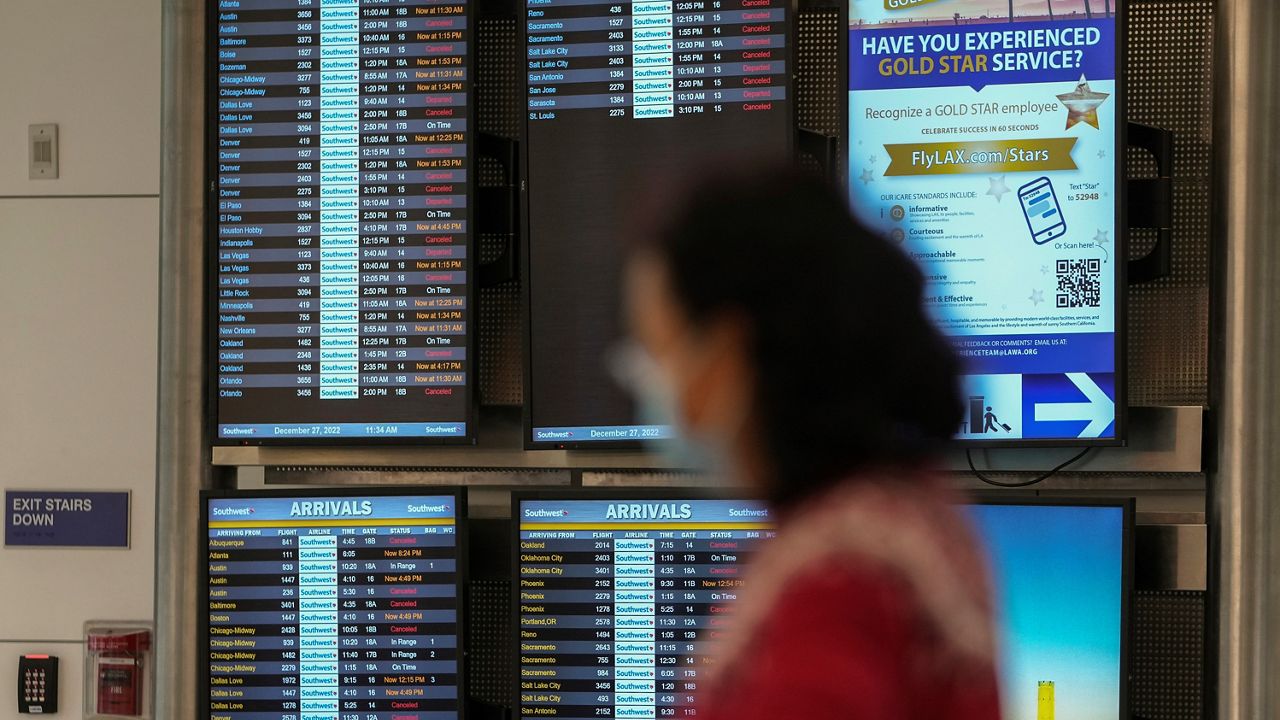 Cancelled Southwest Airlines flights are seen in red on the flight schedules at the Southwest terminal at the Los Angeles International Airport, on Tuesday, Dec. 27, 2022.