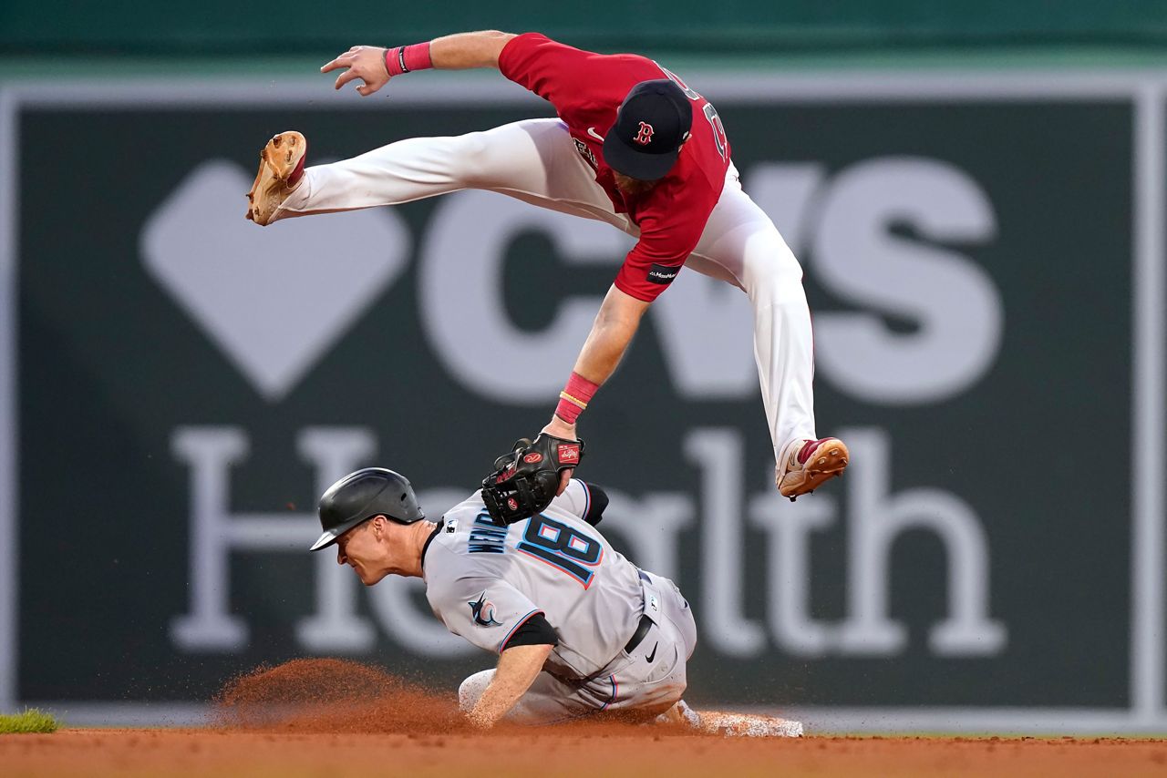 Miami Marlins' Joey Wendle (18) steals second base as Boston Red Sox's Christian Arroyo, top, is unable to tag him during the ninth inning of a baseball game Thursday, June 29, 2023, in Boston. (AP Photo/Steven Senne)