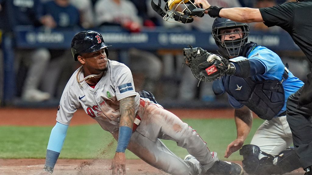 Boston Red Sox's Ceddanne Rafaela, left, scores ahead of the tag by Tampa Bay Rays catcher Ben Rortvedt on a two-run single by Connor Wong during the fifth inning of a baseball game Wednesday, May 22, 2024, in St. Petersburg, Fla. (AP Photo/Chris O'Meara)